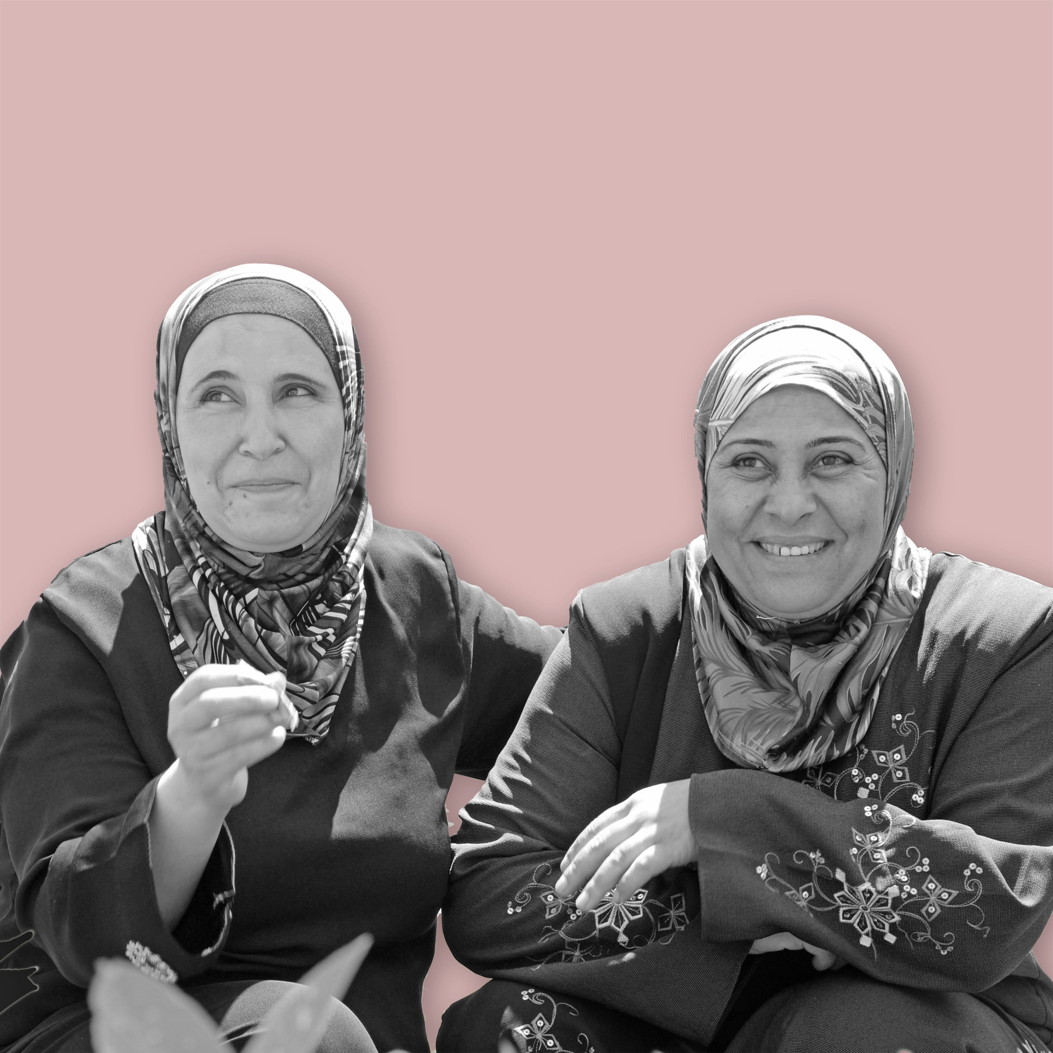 zwei lächelnde Frauen mit bestickten Kleidern und Hidjab / Kopftuch 